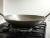 Unlocking the Benefits: Advantages of Using a Wok _Chef tossing fresh vegetables in a traditional carbon steel wok for healthy stir-fry - ChopChic.com