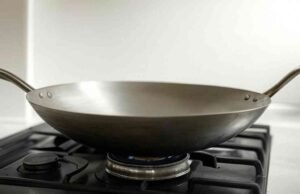 Unlocking the Benefits: Advantages of Using a Wok _Chef tossing fresh vegetables in a traditional carbon steel wok for healthy stir-fry - ChopChic.com