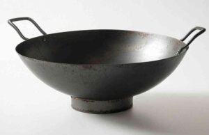 Mastering the Carbon Steel Wok: Advanced Techniques for Wok Hei and Professional Cooking Secrets (Edited) _Chef tossing vegetables in a carbon steel wok over high heat to achieve authentic wok hei - ChopChic.com