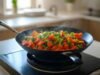 Electric Woks: A Convenient Option for Modern Kitchens Portable electric wok cooking stir fry on a small apartment countertop - ChopChic.com