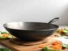 Why Wok Size Matters: Choosing the Right Diameter for Your Cooking Needs _Seasoned carbon steel wok on gas burner showing non-stick patina for stir-frying - ChopChic.com