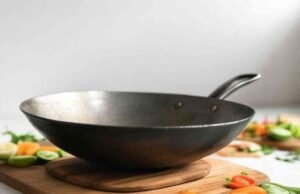 Reviving a Rusty Carbon Steel Wok: A Restoration Guide _Seasoned carbon steel wok on gas burner showing non-stick patina for stir-frying - ChopChic.com
