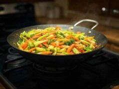 Silicone vs. Stainless Steel Wok Tools: Which is Safe for Seasoning? _Traditional carbon steel wok pan with deep sides for high-heat stir-frying - ChopChic.com