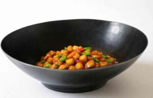 Things to Consider When Choosing a Wok: Features and Tips for Buying the Perfect Wok _Diverse collection of woks including round and flat bottom styles for material and size comparison - ChopChic.com
