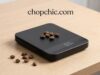 How to Clean and Maintain Your Coffee Scale for Longevity _A close-up view of a microfiber cloth gently wiping the stainless steel surface of a digital coffee scale, carefully avoiding pushing moisture into the USB charging port or button seams.