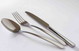 Affordable and Well-Made Satin Flatware Set: LIANYU Satin Flatware Set Review _LIANYU 45-piece satin finish silverware set arranged on a dining table for durability test - ChopChic.com
