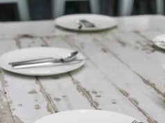 Choosing a Flatware Set for My Kitchen: Satin Finish or Brushed Steel? _Side-by-side texture comparison of satin finish flatware versus brushed steel cutlery on a linen napkin - ChopChic.com