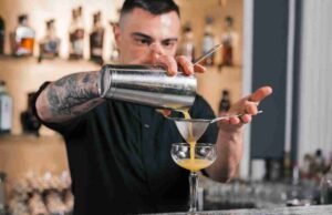 Ranking the 10 Most Stylish Cocktail Whisks for Home Bars _Viski Professional Bar Whisk stirring a cocktail in a crystal mixing glass - ChopChic.com