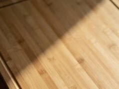 How to Wash Bamboo Cutting Boards (Without Ruining Them) _Hand washing a bamboo cutting board with mild soap and warm water to prevent warping - ChopChic.com