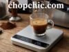 Why a Digital Scale Is a Must for Perfect Espresso Every Time _A compact digital espresso scale placed under a cup on an espresso machine drip tray, displaying the real-time weight and time of the extraction to ensure precise brew ratios.