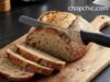 The Best Oil for Wooden Cutting Boards: Mineral Oil vs. Synthetic Alternatives _Mercer Culinary 10-inch wide wavy edge bread knife slicing crusty sourdough loaf without crushing - ChopChic.com