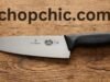 Victorinox Fibrox Pro: Why This Chef’s Knife is the Industry Standard _The Victorinox Fibrox Pro 8-inch Chef's Knife resting on a cutting board next to chopped vegetables, highlighting the textured, non-slip black handle and the stamped stainless steel blade.