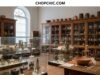 The Most Expensive Kitchen Antiques Ever Displayed in Museums _Rare museum artifacts displaying a porcelain tea cup and silver soup tureens, representing the world's most expensive kitchenware.