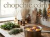 Scentcaping Your Kitchen: Using Natural Aromas to Set the Mood _A simmering pot on a stovetop filled with water, citrus slices, fresh herbs, and cinnamon sticks for natural kitchen scentscaping.