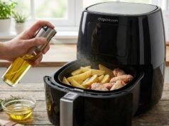 Why I Switched to Refillable Oil Sprayers for My Air Fryer (And Ditched PAM) _A refillable glass oil sprayer misting fresh olive oil onto french fries inside an air fryer basket, contrasted against a commercial aerosol can to illustrate the safe way to coat non-stick surfaces.