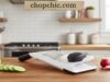 OXO Good Grips Handheld Mandoline Review: The Simple Slicer _A user slicing a cucumber directly into a salad bowl using the OXO Good Grips Handheld Mandoline, highlighting the non-slip handle and the adjustable stainless steel blade.