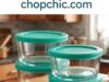 Anchor Hocking SnugFit Review: The Budget Alternative to Pyrex That Actually Holds Up A clear Anchor Hocking SnugFit tempered glass storage container filled with meal-prepped food, demonstrating its flexible plastic lid stretched snugly over the thick glass rim on a kitchen counter.