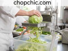 What Is a Lettuce Shredder? (And Why a Knife Can’t Compete) A close-up view of a specialized, wide-body Japanese cabbage shredder on a wooden kitchen prep station, demonstrating a wedge of dense purple cabbage being pushed across its razor-sharp angled blade to produce a mound of ultra-fine, paper-thin shreds.