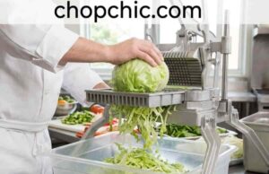 What Is a Lettuce Shredder? (And Why a Knife Can’t Compete) A close-up view of a specialized, wide-body Japanese cabbage shredder on a wooden kitchen prep station, demonstrating a wedge of dense purple cabbage being pushed across its razor-sharp angled blade to produce a mound of ultra-fine, paper-thin shreds.