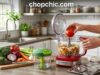 Best Vegetable Choppers: 4 Honest Picks for Every Kitchen A wooden kitchen island displaying four distinct vegetable preparation tools: a heavy-duty push-down grid dicer, a razor-sharp V-blade mandoline slicer, a hand-crank spiralizer, and a compact budget pull-cord chopper, surrounded by uniformly prepped zucchini noodles, sliced cucumbers, and diced onions.