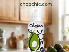 Chosen Foods Avocado Oil Spray Review: The 500°F Solution A sleek white and green Chosen Foods Avocado Oil Spray can resting on the side shelf of a hot, black-rolled steel outdoor griddle, demonstrating its propellant-free mist coating the high-heat cooking surface just before searing steaks.
