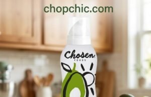 Chosen Foods Avocado Oil Spray Review: The 500°F Solution A sleek white and green Chosen Foods Avocado Oil Spray can resting on the side shelf of a hot, black-rolled steel outdoor griddle, demonstrating its propellant-free mist coating the high-heat cooking surface just before searing steaks.