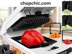 Fullstar Pro Chopper Review: 125,000 Ratings Later, Is It Still Worth It? A clear Fullstar Pro vegetable chopper resting on a kitchen counter, featuring the heavy-duty stainless steel dicing grid locked into the base, the top plastic pusher lid left open to expose the back hinge mechanism, and a pile of uniformly diced onions in the transparent catch tray below.