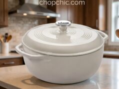 Lodge Enameled Dutch Oven Review: The Le Creuset Killer? A heavy, blue Lodge 6-quart enameled cast iron Dutch oven resting on a wooden cutting board, with its thick cast iron lid lifted slightly to reveal a steaming, perfectly blistered artisan sourdough boule inside.