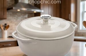 Lodge Enameled Dutch Oven Review: The Le Creuset Killer? A heavy, blue Lodge 6-quart enameled cast iron Dutch oven resting on a wooden cutting board, with its thick cast iron lid lifted slightly to reveal a steaming, perfectly blistered artisan sourdough boule inside.