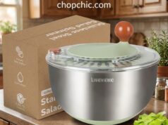 Lunememo Salad Spinner Review: Premium vs. Plastic A sleek Lunememo 5.3-quart stainless steel salad spinner resting on a granite kitchen counter, featuring a clear plastic lid with a hand-crank rotary handle and an instant stop button, while its silicone non-slip base grips the surface next to a pile of freshly washed lettuce.