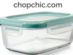 OXO Good Grips Smart Seal Glass Container Review: The Workhorse of Food Storage A close-up view of a clear OXO Smart Seal Glass container filled with meal-prepped food, with its lid resting alongside to display the four heavy-duty plastic locking tabs and the removable silicone gasket.