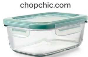 OXO Good Grips Smart Seal Glass Container Review: The Workhorse of Food Storage A close-up view of a clear OXO Smart Seal Glass container filled with meal-prepped food, with its lid resting alongside to display the four heavy-duty plastic locking tabs and the removable silicone gasket.