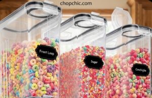 PRAKI Cereal Containers Review: 6 Containers, One Pour Spout, One Real Flaw A clear plastic PRAKI cereal container filled with bran flakes, featuring a black locking lid with an open flip-top pour spout, sitting on a kitchen counter next to a customized chalkboard storage label.