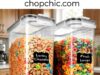 Shazo Extra Large Cereal Containers Review: Does Size Actually Solve the Stale Problem? A large, clear 6.3L Shazo plastic storage container completely filled with a family-size box of cereal, highlighting its black four-hinge locking lid, internal silicone gasket, and flip-top pour spout on a deep pantry shelf.