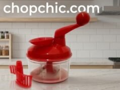 Tupperware Quick Chef Pro System Review: Is a Premium Manual Chopper Worth It? A detailed close-up of the Tupperware Quick Chef Pro System on a modern kitchen counter, with the transparent base revealing the aggressive three-blade stainless steel attachment chopping onions and carrots, highlighting the internal gear mechanism within the ergonomic pull-cord lid and the integrated funnel.