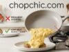 The Best Non-Toxic Pan for Scrambled Eggs: 3 Picks That Actually Slide A detailed close-up photograph taken in a modern kitchen, capturing a chef's hand tilting a light-gray ceramic-coated non-stick frying pan, revealing a perfect, cohesive stream of soft, creamy scrambled eggs sliding flawlessly onto a white ceramic plate. The text "chopchic.com" is overlayed across the top in a clean, sans-serif font. To the left, a stylized diagram with a flame and a temperature gauge contrasts a high flame with a red X and "HIGH HEAT: STICKING" against a low flame with a green checkmark and "LOW HEAT: PERFECT SLIDE," referencing the heat control secret. Natural, warm light illuminates the scene, emphasizing the non-stick surface and fluffy eggs.