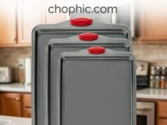 Boxiki Kitchen Carbon Steel Review: Engineering the High-Heat Bake An extreme close-up of a dark gray Boxiki Kitchen heavy-gauge carbon steel baking sheet remaining perfectly flat inside a 420°F oven while evenly roasting vegetables, featuring a diagrammatic overlay illustrating how the thick rim geometry resists thermal torsion and eliminates warping.