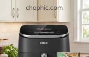 Cosori TurboBlaze 6 QT Review: High-Speed Ceramic Performance A close-up photograph of a matte black Cosori TurboBlaze Air Fryer sitting on a light gray quartz kitchen countertop. The basket is slightly pulled out, revealing a glossy, dark ceramic coating (PFAS-free) and filled with perfectly air-fried, golden-brown chicken wings. A stylized infographic inlay on the bottom-right corner illustrates a simplified 5-speed DC motor diagram, and the text "chopchic.com" is cleanly rendered at the top-right corner of the visual.