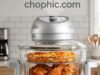 Halogen Convection Physics: The Granitestone 16Qt Glass Air Fryer Analysis A professional technical photograph captured in a modern, light-filled kitchen, focusing on the Granitestone 16Qt Halogen Oven with an active cooking process inside. The sleek black appliance with metallic accents sits on a white quartz countertop. Its tempered glass lid reveals a whole roasted turkey and vegetables, emphasizing the massive 16-quart capacity. A glowing halogen element is active. Integrated callouts point from a nearby printed document to the appliance: one with a green checkmark regarding 'Halogen Bulb Durability (by A. Kanter)' and another with a molecule icon regarding 'Non-Toxic Safety (by Larry)'. A digital thermometer probe is shown inserting into the turkey, reading a safe high internal temperature. Natural light from a window in the background illuminates the scene, highlighting textures. A website watermark is positioned at the very top of the image.
