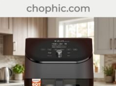 Instant Pot Vortex Plus 6QT Air Fryer Review: The ClearCook Material Analysis A technical infographic photograph analyzing the Instant Pot Vortex Plus 6QT Air Fryer on a modern quartz kitchen countertop. Perspective is eye-level, slightly angled. Features several callout text elements with clean lines and icons, as if on a review screen. The main subject, the Instant Pot Vortex Plus 6QT, is front and center. Its ClearCook window is illuminated, showing golden-brown French fries actively cooking inside. Integrated seamlessly on a glass panel backsplash is a website watermark.