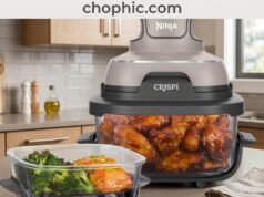 Ninja Crispi 4-in-1 Glass Air Fryer Review: The Death of the Plastic Basket A professional product photograph of the Ninja Crispi system on a modern kitchen counter. The 1500W PowerPod is shown mounted atop a clear, heavy-duty borosilicate glass container filled with crispy roasted vegetables. The image emphasizes the complete absence of plastic and PFAS-coated surfaces. A website watermark is positioned at the very top center of the frame.